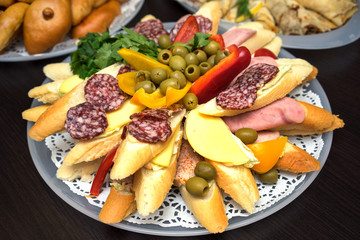 bread with cheese and salami sliced on round plate