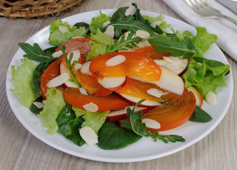 Salad greens with persimmon and almonds