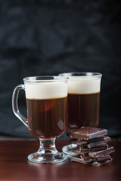 traditional strong irish coffee on wooden bar with dark chocolat