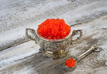 Salmon red caviar in silver bowl