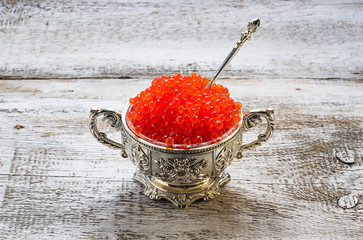 Salmon red caviar in silver bowl