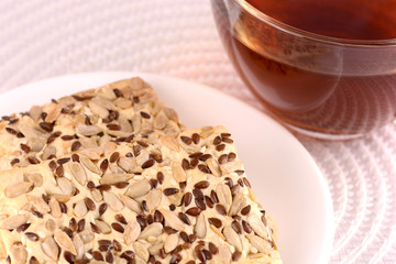 sweet cake on white plate with tea (coffee) cup