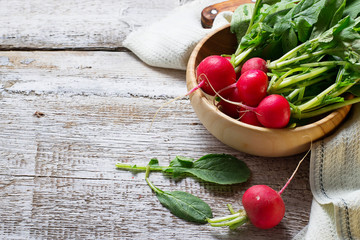 Fresh radishes on wooden background