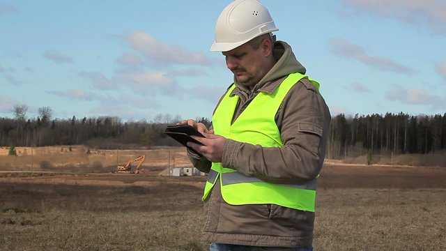 Engineer working with tablet PC on the field
