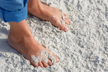 Close up of child feet on a tropical sandy beach, Florida