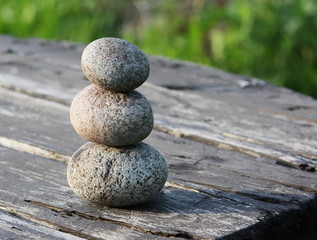 Fototapeta na wymiar A pile of stones on wooden table