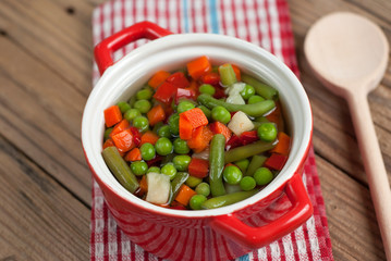 Vegetable soup on old wooden table