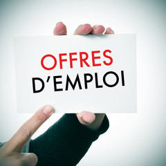 woman with a signboard with the text offres d'emploi, jobs in fr