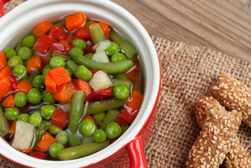 Vegetable soup on old wooden table