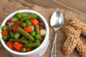 Vegetable soup on old wooden table