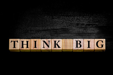 Message THINK BIG  isolated on black background