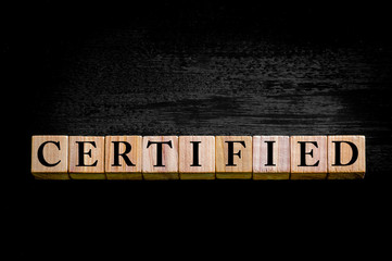 Word CERTIFIED isolated on black background