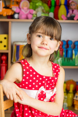 6 years old girl blond hair, red dress with white polka dots