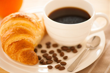 cup of coffee and croisants served for breakfast