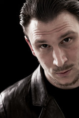 Handsome and sexy man closeup portrait on black background