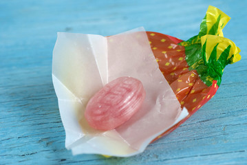 Wrapped candy on old wooden table