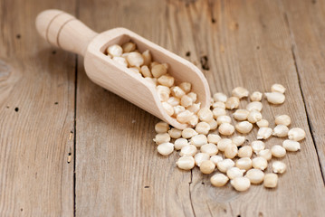 White corn and wooden spoon on old wooden table