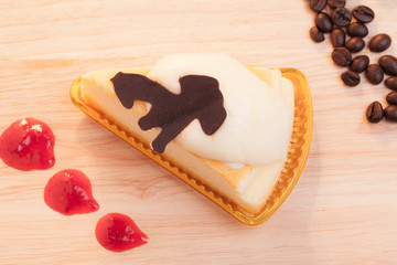 cheese custard cake and cup of coffee on wood.
