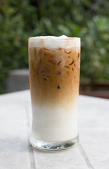 Iced coffee with milk is on the table.