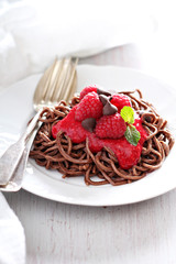 Cooked chocolate pasta with raspberry sauce