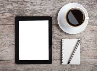 empty tablet with note paper and coffee on the wooden table