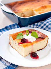 Appetizing cottage cheese casserole on white plate close up