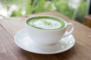 Matcha green tea latte beverage in glass.