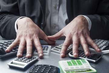 male business hands with calculators