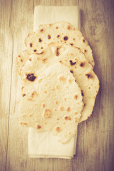  flour tortillas on a wooden table. Unleavened bread.