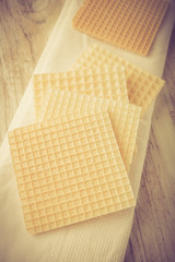 Vintage photo of wafers on white wooden table
