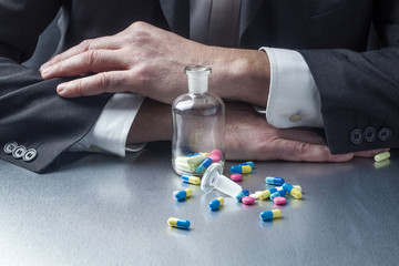 businessman taking pills and drugs for facing work schedules