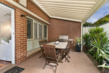 Backyard cozy patio area with wicker furniture set