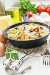 Omelet with mushrooms and tomatoes. Frittata