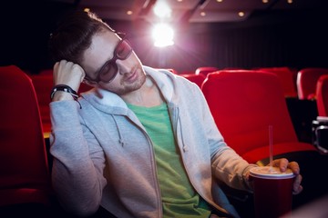 Young man sleeping in chair