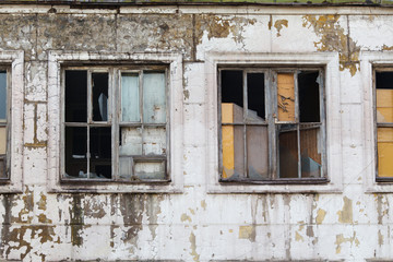Broken window on the old wall