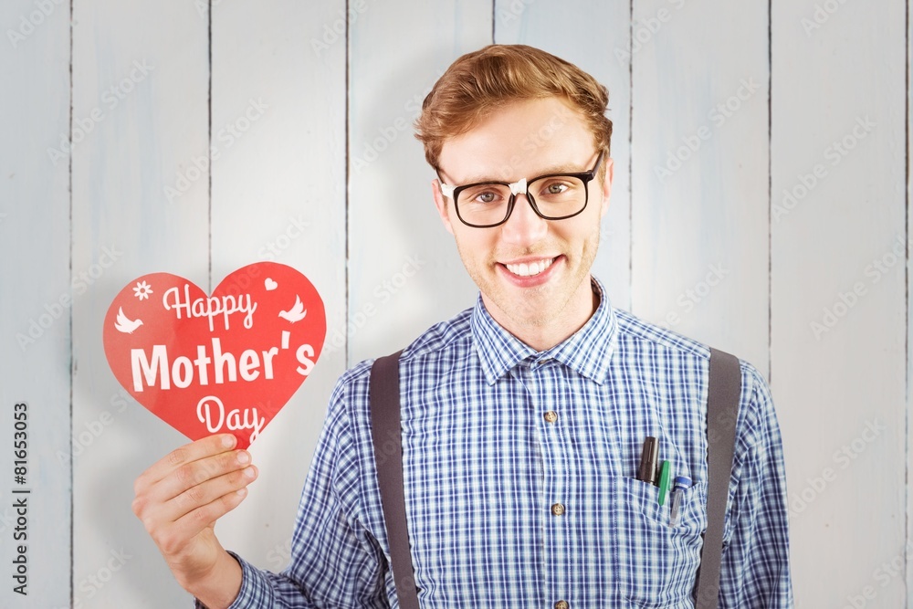 Poster Composite image of geeky hipster holding a heart card