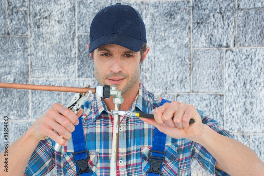 Poster Composite image of plumber fixing pipe over white background