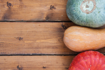 Different pumpkins on wooden background