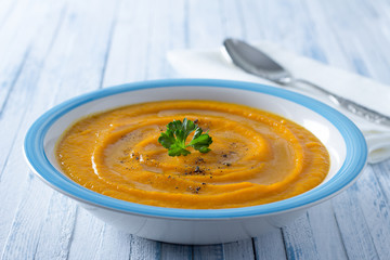 Carrot cream soup with spices and parsley