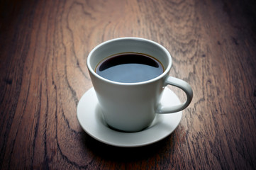 Vintage tone Color a cup of Coffee on the wooden table