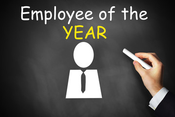 hand writing employee of the year on black chalkboard