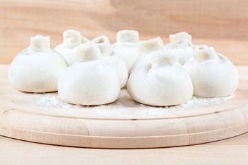 Fototapeta na wymiar Manti dumplings on a wooden board.