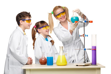 Teens and teacher of chemistry at  lesson making experiments