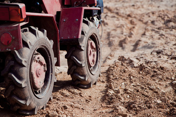 Little tractor a field in the spring 