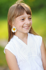 portrait of little girl outdoors in summer