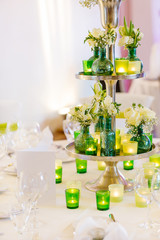 Elegant table set in green and white for wedding or event party.