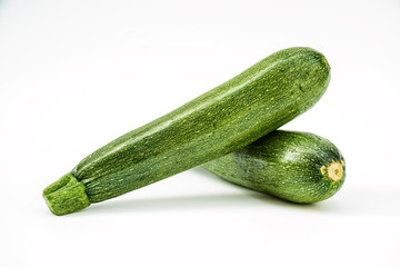 Fresh healthy green zucchini isolated on white background .
