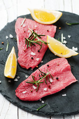 Uncooked meat with rosemary and salt