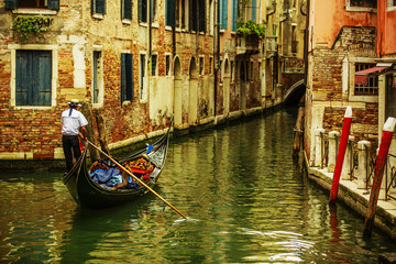 Fototapeta na wymiar Venice, Italy - Gondolier and historic tenements (filtered)