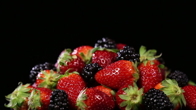 Fresh tasty berries on black background